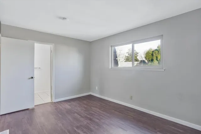 a view of room with window and wooden floor
