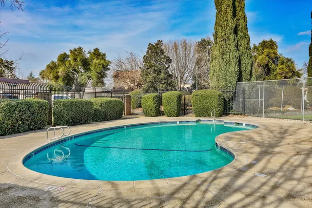 a view of a swimming pool with a yard