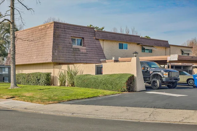 a view of a car is parked in front of a building