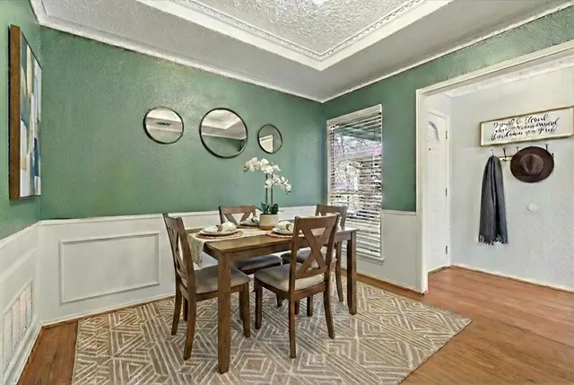 a view of a dining room with furniture and wooden floor