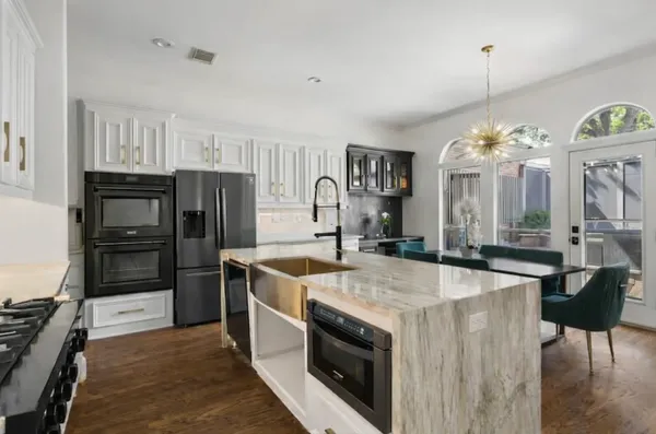 a kitchen with a stove and a refrigerator