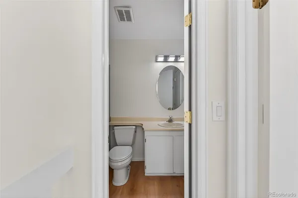 a bathroom with a toilet a sink and a mirror