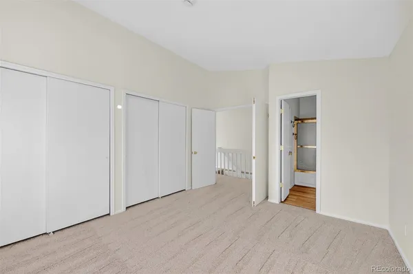 a view of hallway with wooden floor