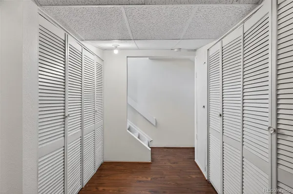 a view of hallway with stairs and wooden floor