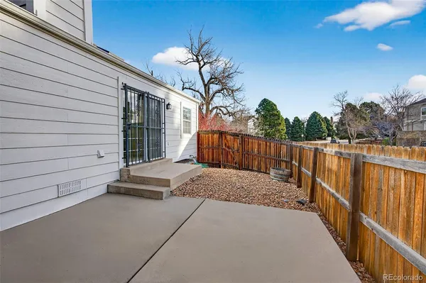 a view of a house with wooden fence