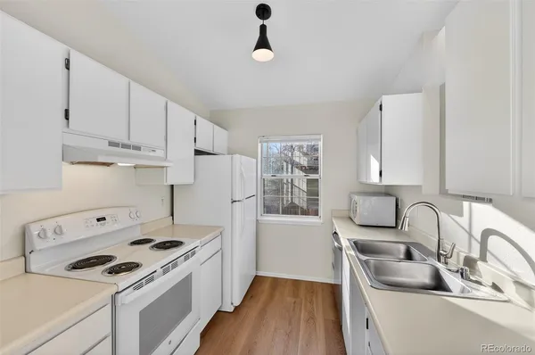 a kitchen that has a sink and a stove in it