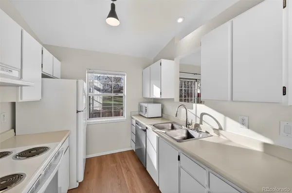 a kitchen that has a sink and a stove