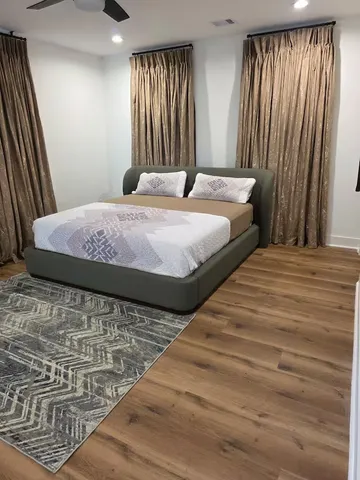 a bedroom with a bed and large window