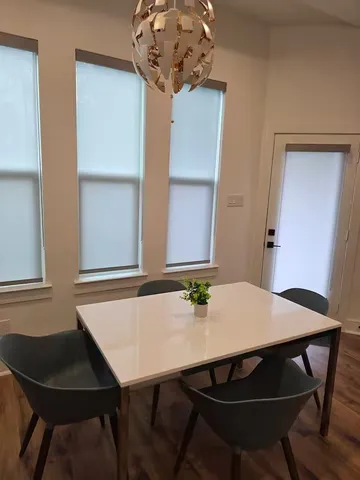 a view of a dining room with furniture and wooden floor
