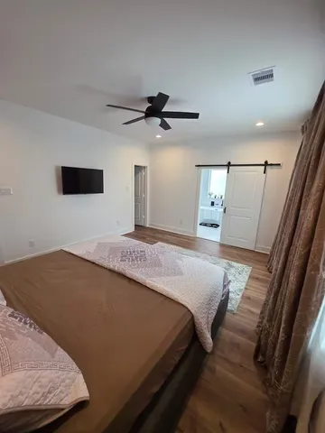 a bedroom with a bed and a flat screen tv