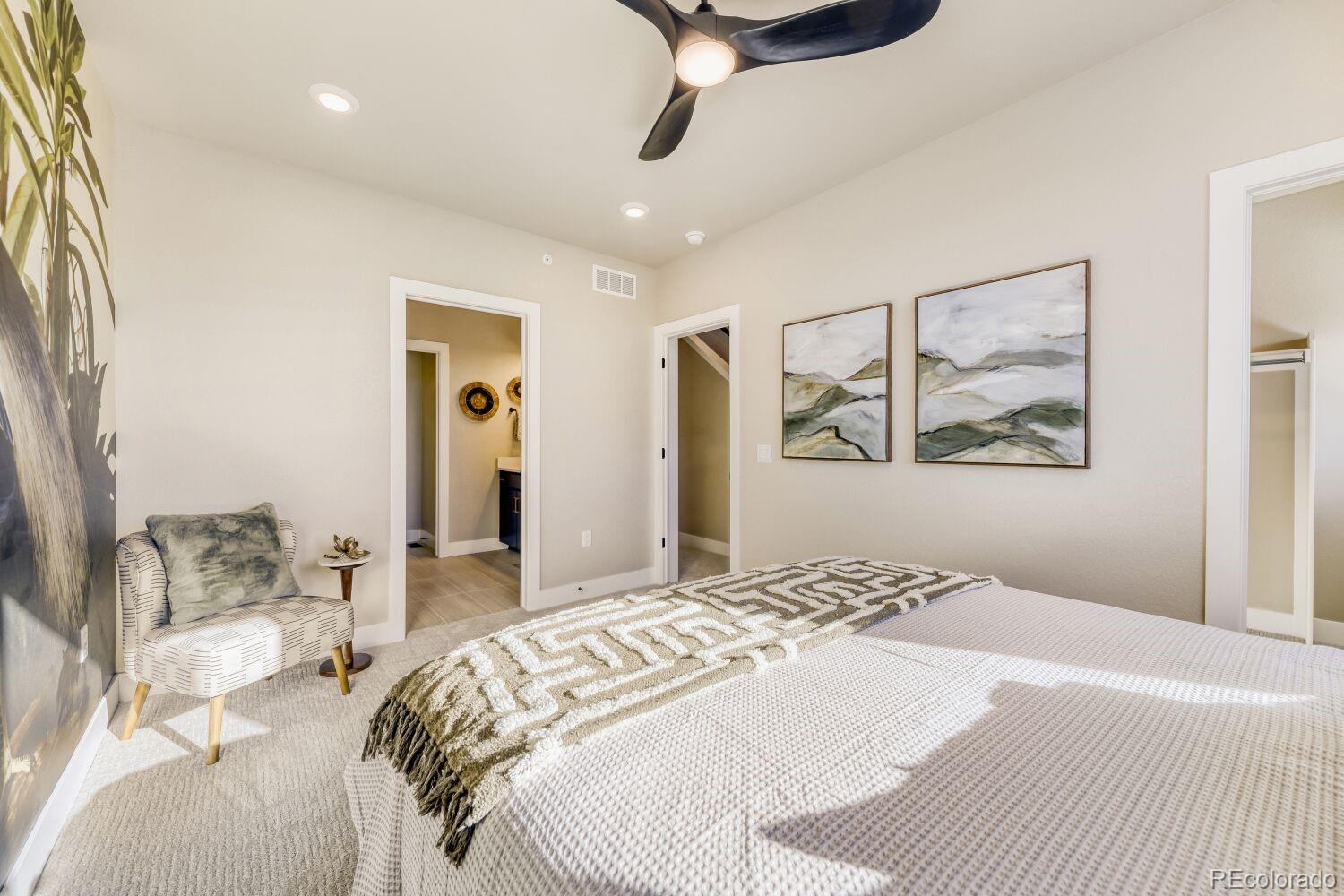 9195 Pierce Street, Unit 2 Westminster, CO 80021 - Photo 17 of 28 a bedroom with a large bed and a chandelier