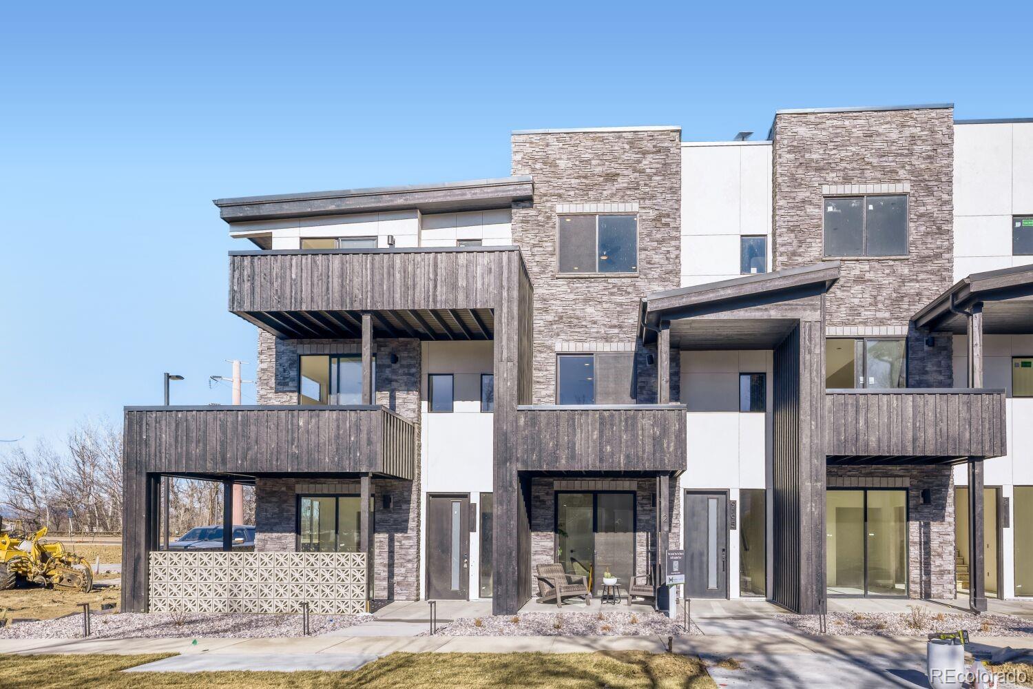 9195 Pierce Street, Unit 2 Westminster, CO 80021 - Photo 2 of 28 a front view of a house with garden