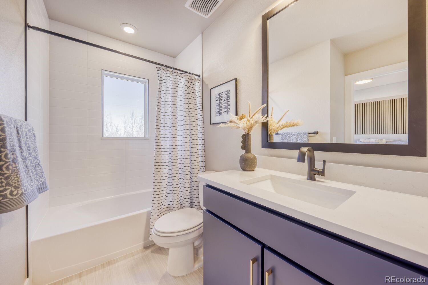 9195 Pierce Street, Unit 2 Westminster, CO 80021 - Photo 21 of 28 a bathroom with a sink a toilet and shower