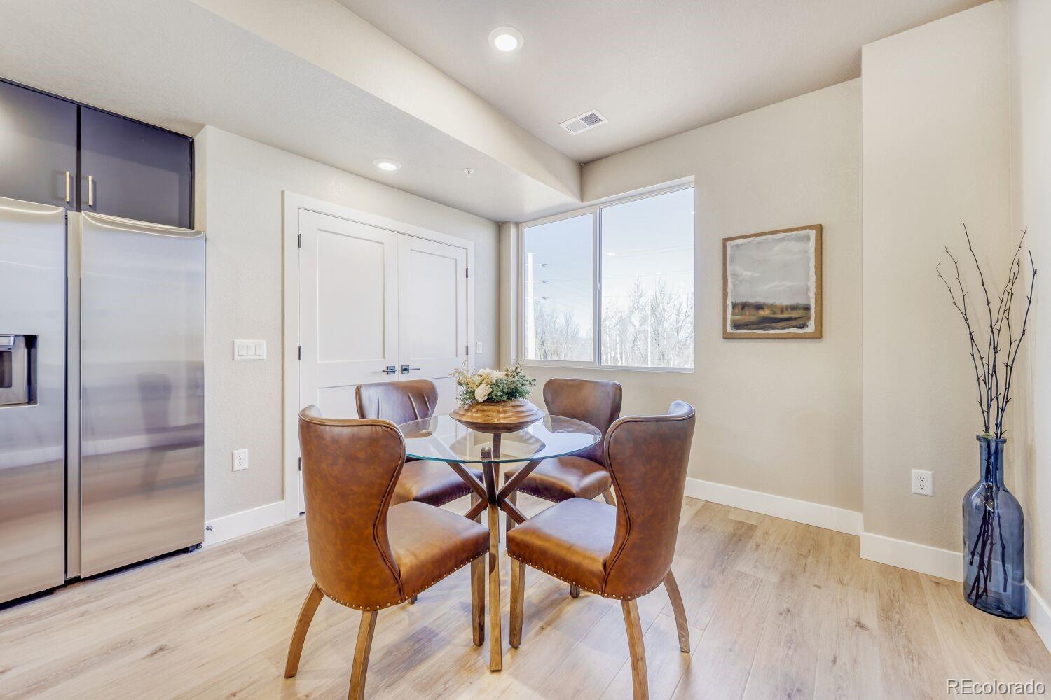 9195 Pierce Street, Unit 2 Westminster, CO 80021 - Photo 6 of 28 a view of a dining room with furniture and wooden floor