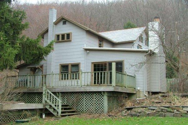 1384 Cherry Valley Road Stroudsburg, PA 18360 - Photo 4 of 18 a view of a house with a wooden deck and furniture