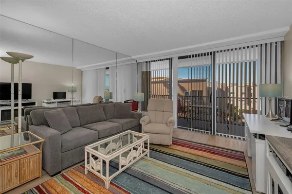 a living room with furniture and a floor to ceiling window