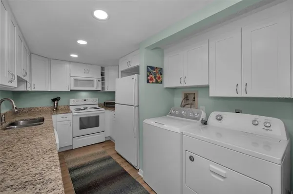 a white refrigerator freezer sitting inside of a kitchen