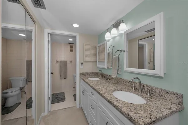 a bathroom with a glass shower door