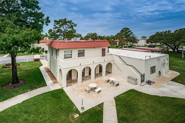 an aerial view of residential houses with outdoor space and trees