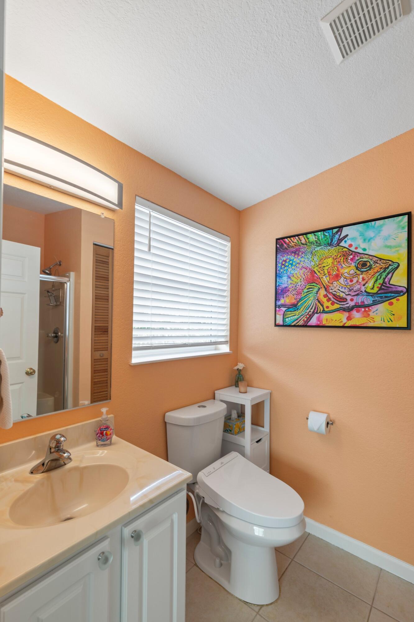 157 Mars Lane Key West, FL 33040 - Photo 23 of 41 a bathroom with a toilet a sink and a mirror