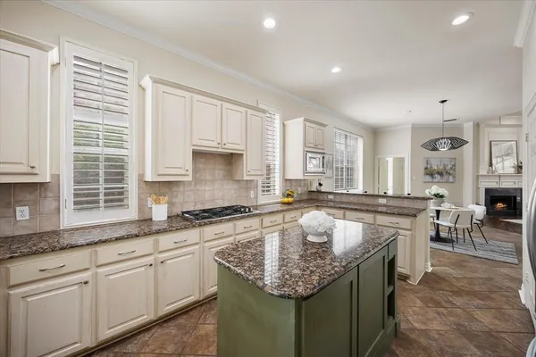a kitchen with stainless steel appliances granite countertop a sink stove and cabinets