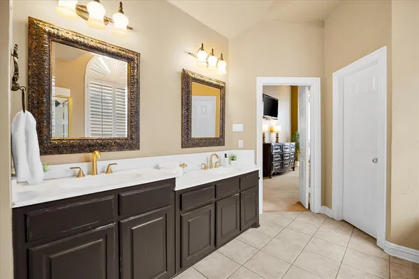 a bathroom with a double vanity sink mirror and