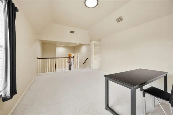 a view of a hallway to a bedroom and a balcony