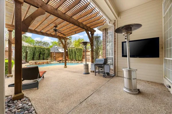 a view of a patio with a table and chairs