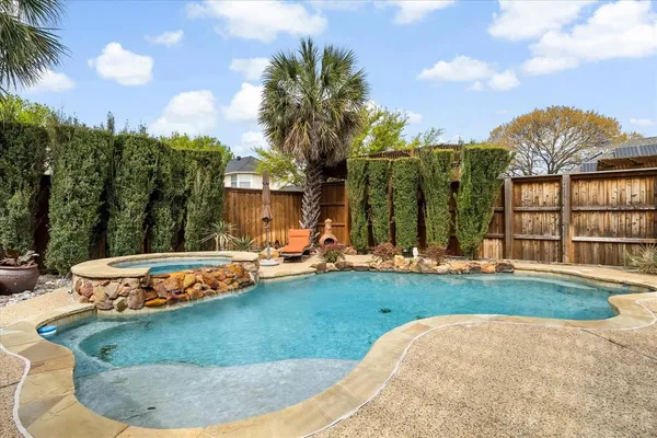 a view of a house with swimming pool and porch