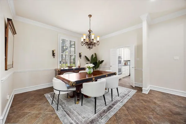 a view of a dining room with furniture and chandelier