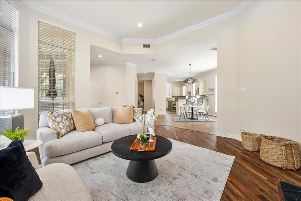 a living room with furniture and a wooden floor