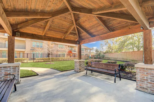 a front view of a house with a yard and potted plants