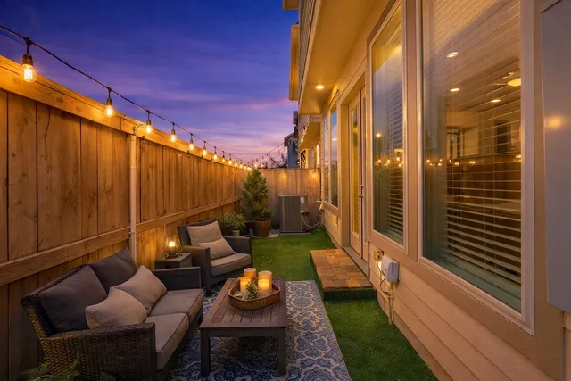 a balcony with furniture and a potted plant