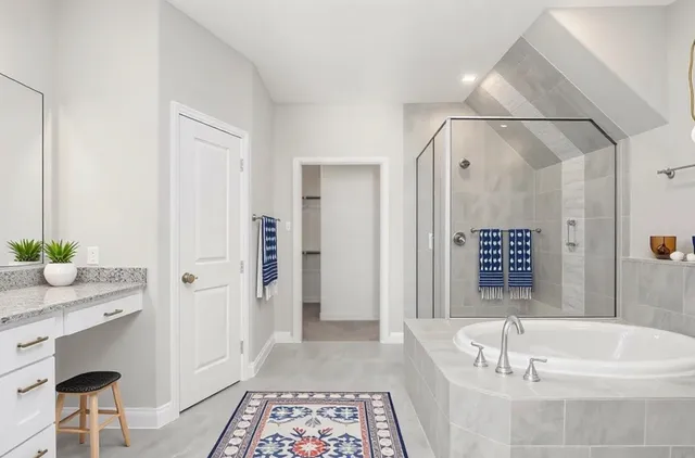 a bathroom with a tub a sink and a shower