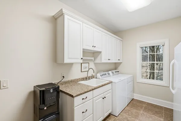 a utility room with cabinets washer and dryer