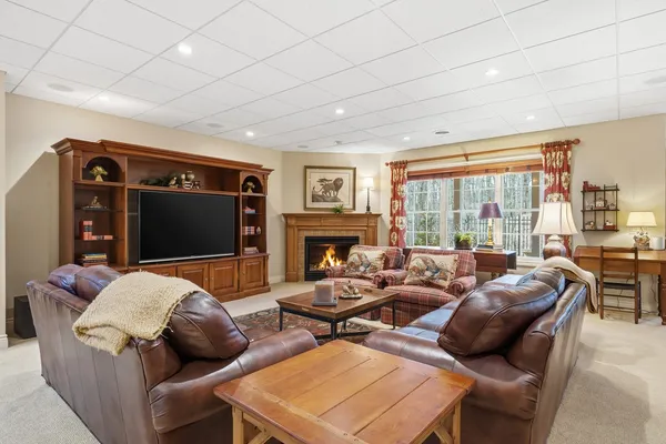 a living room with furniture a flat screen tv and a fireplace