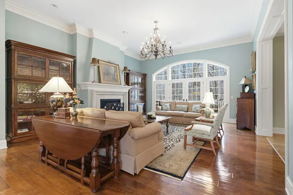a living room with fireplace furniture and a chandelier