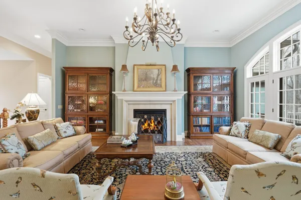 a living room with furniture fireplace and a large window