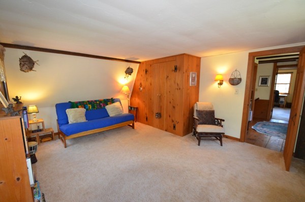 34 Chestnut Hill Road Leverett, MA 01054 - Photo 16 of 29 a bedroom with a bed and a chair