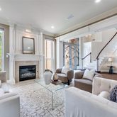 a living room with furniture fireplace and a large window