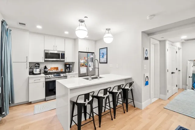 a kitchen with kitchen island a dining table and appliances