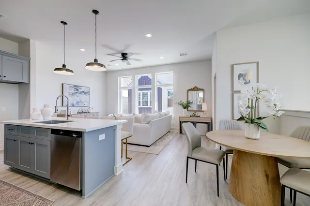 a view of a kitchen area with furniture and wooden floor