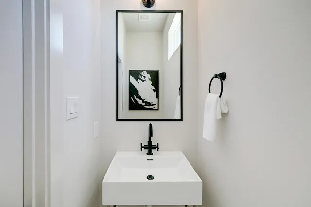 a bathroom with a sink and mirror