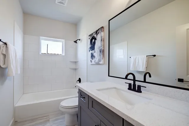 a bathroom with a sink a toilet and a bathtub
