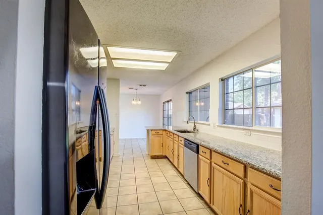 a spacious bathroom with a granite countertop sink and a large mirror