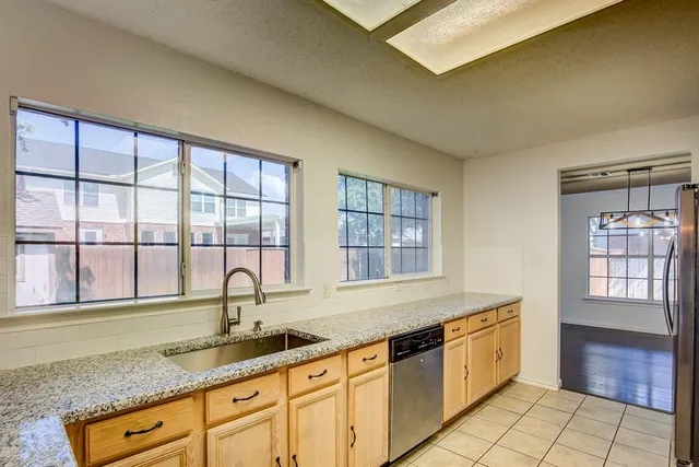 a kitchen with granite countertop a sink and a window
