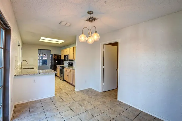 a view of a kitchen from the hallway