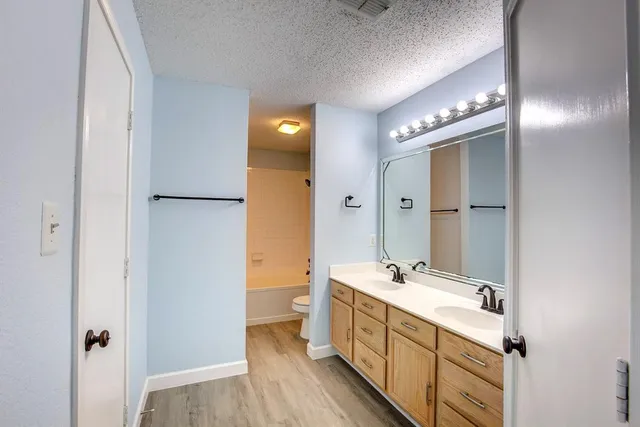 a spacious bathroom with a double vanity sink and a mirror