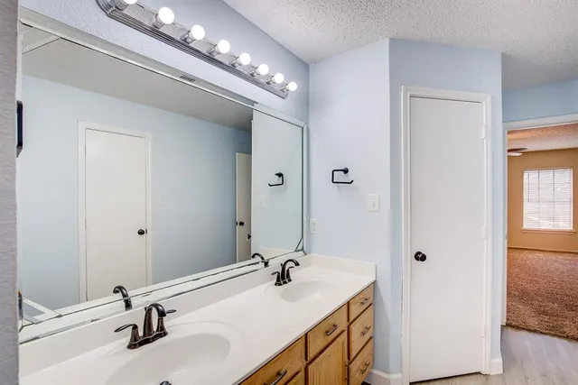 a bathroom with a double vanity sink and a mirror