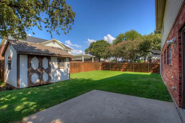 a view of a tiny house with a yard
